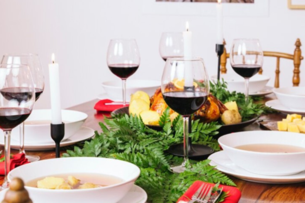 Beautifully set holiday table with seasonal decorations, elegant tableware, and a festive centerpiece