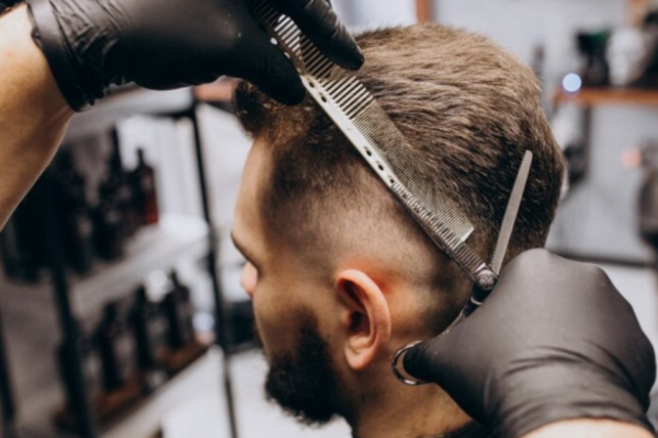 Hairdresser cutting hair in a salon, symbolizing transformation and personal growth.